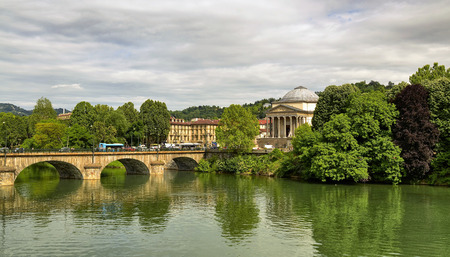 Turin, Piedmont, Italy. May 2019. The church of the great mother filmed from the bank of the river Po on the side of Piazza Vittorio. The traffic of private and public vehicles runs along the bridge.のeditorial素材