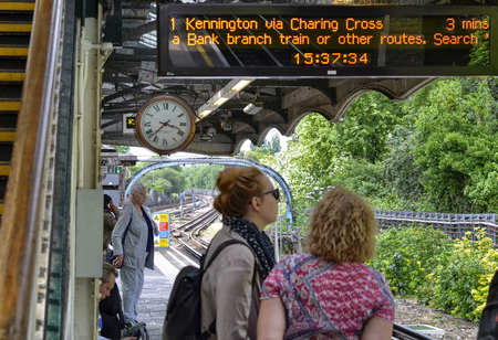 London, United Kingdom, June 14 2018. A vintage symbol of London: the clock with hands visible in almost all metro stops. With its retro look, it stands out from the context.のeditorial素材