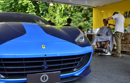 Turin, Piedmont, Italy. June 2018. At the Valentino park, the motor show. At the Ferrari stand, detail of a sports car with a curious two-tone blue color. The Ferrari emblem is in evidence.のeditorial素材