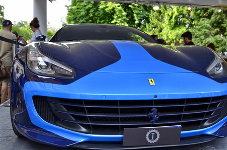 Turin, Piedmont, Italy. June 2018. At the Valentino park, the motor show. At the Ferrari stand, detail of a sports car with a curious two-tone blue color. The Ferrari emblem is in evidence.のeditorial素材