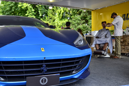 Turin, Piedmont, Italy. June 2018. At the Valentino park, the motor show. At the Ferrari stand, detail of a sports car with a curious two-tone blue color. The Ferrari emblem is in evidence.のeditorial素材