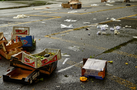 Turin, Piedmont, Italy. May 2019. After the development of the local market, various waste remains on the ground. The employees take care of collecting everything and cleaning up the square.のeditorial素材