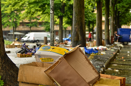 Turin, Piedmont, Italy. May 2019. After the development of the local market, various waste remains on the ground. The employees take care of collecting everything and cleaning up the square.のeditorial素材