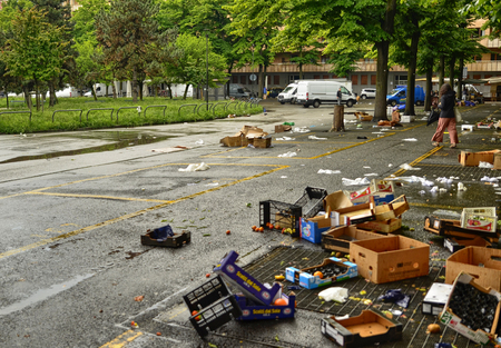 Turin, Piedmont, Italy. May 2019. After the development of the local market, various waste remains on the ground. The employees take care of collecting everything and cleaning up the square.のeditorial素材