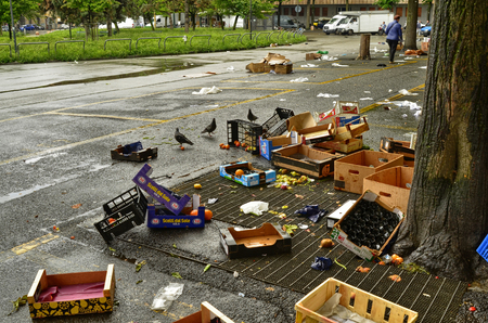 Turin, Piedmont, Italy. May 2019. After the development of the local market, various waste remains on the ground. The employees take care of collecting everything and cleaning up the square.のeditorial素材