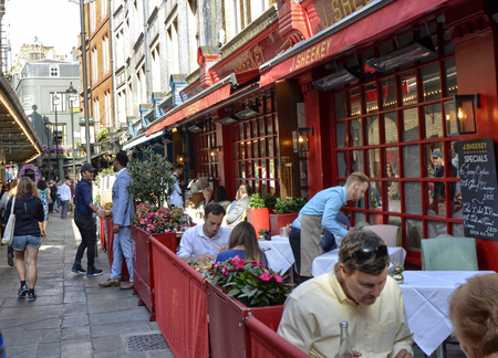 London, United Kingdom, June 14 2018. One of the many pubs in central London: friends meet to drink beer and eat something at all hours of the day.のeditorial素材