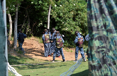 Battle at paintball. A small group of young players, fully equipped, are positioned to start the fight.の写真素材