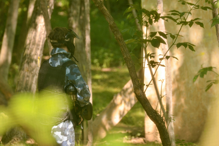 Paintball battle. Players take advantage of the woods to lurk and shoot at opponents.の写真素材