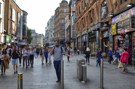 London, United Kingdom, June 2018. The appearance of the city around the Leicester square metro station. Double-decker buses, taxis called cabs, crowds of tourists.のeditorial素材