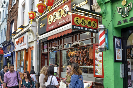 London, United Kingdom, June 2018. The chinatown district: a swarm of Chinese tradition in restaurants with bright colors and a crowd of tourists. A specialty on all the crispy duck.のeditorial素材
