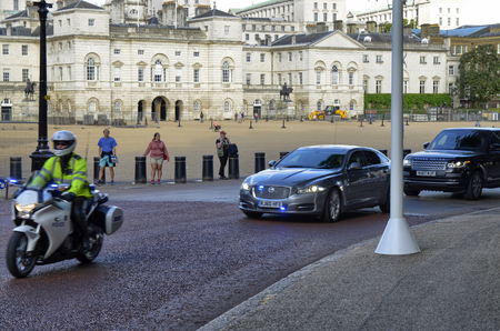 London, United Kingdom, 14 June 2018. Passing by VIP car with police escort in tow, in the background The Household Cavalry Museum.のeditorial素材