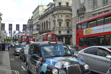 London, United Kingdom, 14 June 2018. London taxis, called cabs, are one of the symbols of the city. Classically of strictly black color. Sometimes with colorful sponsorships.のeditorial素材