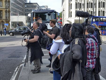 London, United Kingdom, June 2018. TV crew stationed in front of the abbey entrance of Westminster Abbey on the occasion of a mundane event. They study the best shot.のeditorial素材