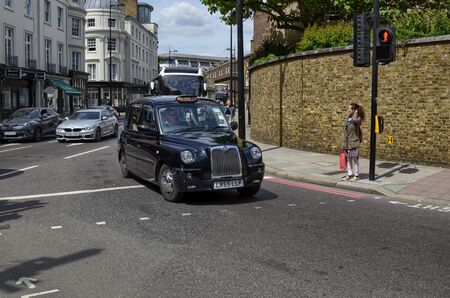 London, United Kingdom, June 2018. London taxis, called cabs, are one of the symbols of the city. Classically of strictly black color. Sometimes with colorful sponsorships.のeditorial素材