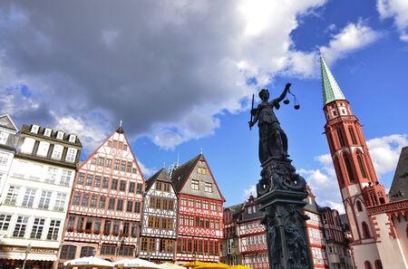 Frankfurt am Main, Germany, August 2019. The RÃ¶merberg square is characterized by the fountain of justice. The statue holds the symbolic plates of the scale, moved lightly by the wind like clouds.のeditorial素材