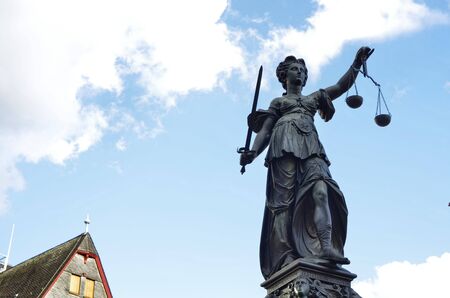 Frankfurt am Main, Germany, August 2019. The RÃ¶merberg square is characterized by the fountain of justice. The statue holds the symbolic plates of the scale, moved lightly by the wind like clouds.のeditorial素材