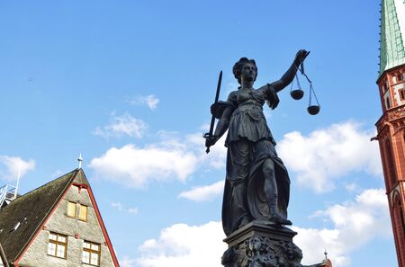Frankfurt am Main, Germany, August 2019. The RÃ¶merberg square is characterized by the fountain of justice. The statue holds the symbolic plates of the scale, moved lightly by the wind like clouds.のeditorial素材