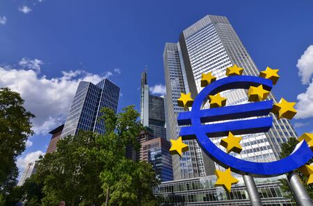 Frankfurt am Main, Germany, August 2019.  The Eurotower. White clouds on the blue sky. Highlighted on the right is the blue Euro symbol with yellow stars.のeditorial素材