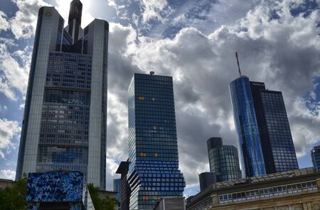 Frankfurt am Main, Germany. August 2019. Modern skyscrapers. They have mirrored facades that reflect the surrounding world creating particular effects.のeditorial素材
