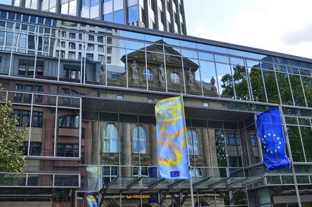 Frankfurt am Main, Germany. August 2019. Modern skyscrapers. They have mirrored facades that reflect the surrounding world creating particular effects.のeditorial素材