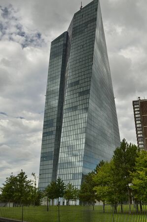 Frankfurt am Main, Germany, August 2019. The new headquarters of the ECB is a skyscraper with a very modern design: steel glass gives a mirrored facade that reflects the sky and the surrounding cloudsのeditorial素材