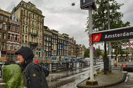 Amsterdam, Holland, August 2019. Leaving the train station you will find information boards for...