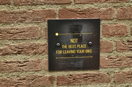 Amsterdam, Holland, August 2019. The alleys of the old town on a rainy day. The houses look a bit gloomy but the tourists are always present. A plate invites you not to park your bike here.のeditorial素材