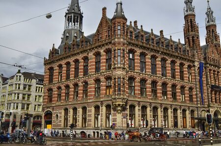Amsterdam, Holland. August 2019. Behind Piazza Dam, Il Magna Plaza: the luxury shopping center in the historic center. The beauty of the red brick building strikes tourists.のeditorial素材