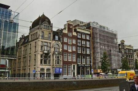 Amsterdam,Holland.August 2019.The historic center is characterized by the appearance of the typical houses on the street. They are kept in perfect condition with maintenance work: scaffolding visibleのeditorial素材