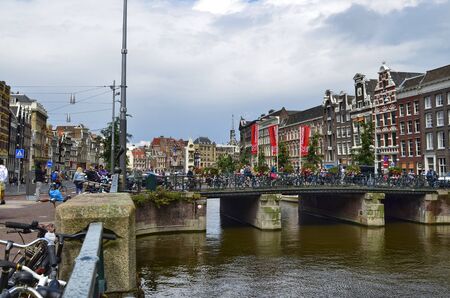 Amsterdam, Holland. August 2019. The bridges, decorated with brightly colored flowers, are a reference point for tourists to take a souvenir photo.のeditorial素材