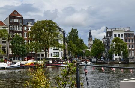 Amsterdam, Holland. August 2019. The large tourist boats that crowd the canals of the historic center: they move all day transporting large numbers of visiting tourists.のeditorial素材