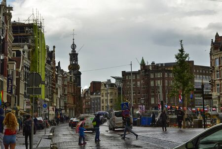 Amsterdam, Holland. August 2019. The mint tower acts as a reference point in the historic center. Even from afar it stands out and makes itself known. Blue sky with white clouds.のeditorial素材