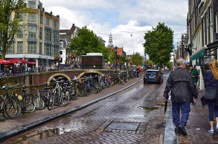 Amsterdam, Holland. August 2019. Bicycles are a symbol of the city, they are often parked on the railings of canals.のeditorial素材