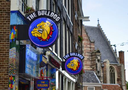 Amsterdam, Holland. August 2019. In the red light district The Bulldog is the most famous coffeeshop. Characteristic is the sign with the dog with the spying collar.のeditorial素材