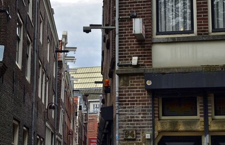Amsterdam, Holland. August 2019. Detail of the top of the facade of a typical house in the center, a beam protrudes from the roof: on it a pulley was applied to hoist the materials.のeditorial素材