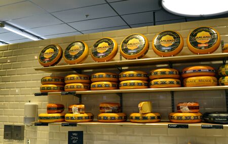 Amsterdam, Holland, August 201. Typical Dutch cheese shapes: displayed on shelvess, catch the attention of the mall's customers.のeditorial素材
