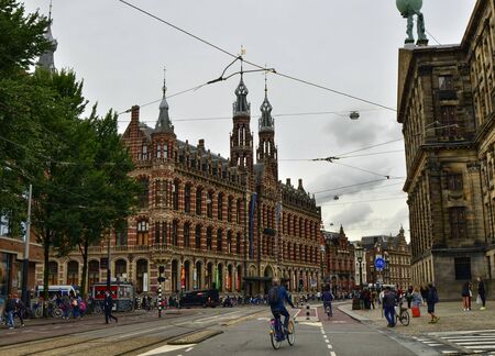 Amsterdam, Holland, August 201. Exterior view from the street of the Magna Plaza shopping center. Red brick neo-gothic building, people are on the street.のeditorial素材