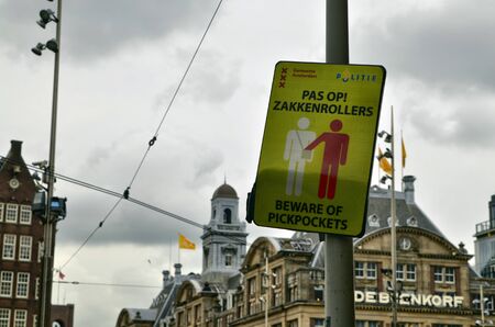 Amsterdam, Holland, August 201. Signage to warn against the cheerleaders who frequent crowded places. The graphic of the sign symbolizes the gesture of pickpocketing.のeditorial素材