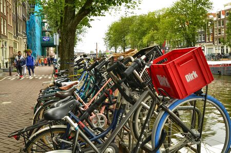 Amsterdam, Holland, August 2019. In the historic center a view that is a symbol of the city: a long line of bicycles parked along a canal.のeditorial素材