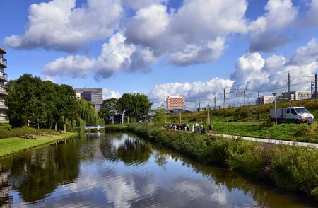 Amsterdam, Holland, August 2019. On the outskirts the canals are lined only with trees and greenery....