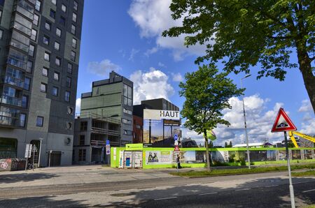Amsterdam, Holland, August 2019. Several modern skyscrapers are located in the modern suburbs of the city. With extensive use of glass and steel they have facades that reflect the clouds in the sky.のeditorial素材