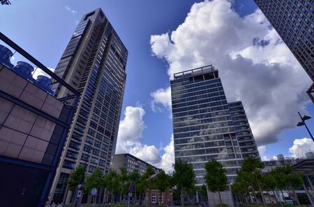 Amsterdam, Holland, August 2019. Several modern skyscrapers are located in the modern suburbs of the city. With extensive use of glass and steel they have facades that reflect the clouds in the sky.のeditorial素材