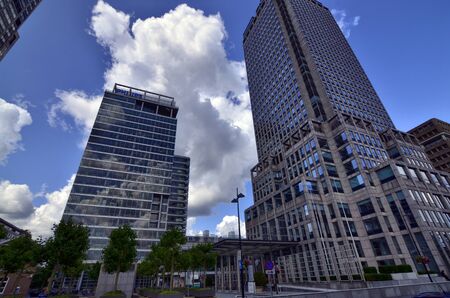Amsterdam, Holland, August 2019. Several modern skyscrapers are located in the modern suburbs of the city. With extensive use of glass and steel they have facades that reflect the clouds in the sky.のeditorial素材