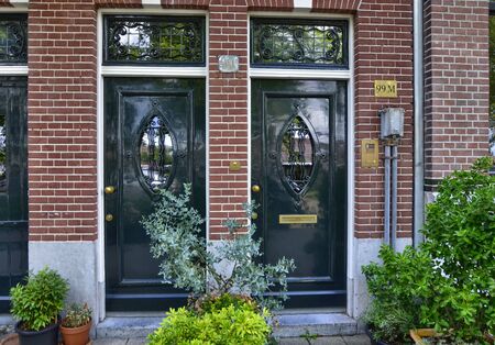 Amsterdam, Holland, August 2019. Along the river Amstel, on the outskirts of the city it is easy to meet house doors with a strong appeal to the London style.のeditorial素材