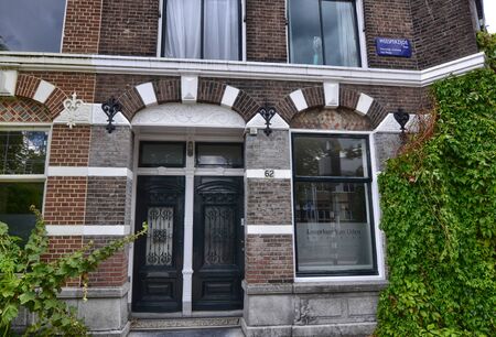Amsterdam, Holland, August 2019. Along the river Amstel, on the outskirts of the city it is easy to meet house doors with a strong appeal to the London style.のeditorial素材