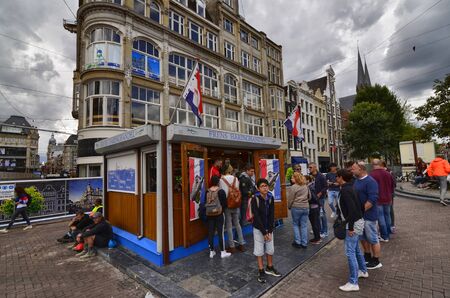 Amsterdam, Holland, August 2019. A kiosk of herring sandwiches and other fresh fish. Some customers are queuing to be served while others are already eating their sandwichのeditorial素材