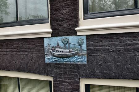 Amsterdam, Holland, August 2019. Artistic detail on the facade of a house in the center: date 1699 visible.のeditorial素材