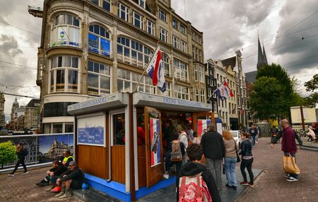 Amsterdam, Holland, August 2019. A kiosk of herring sandwiches and other fresh fish. Some customers are queuing to be served while others are already eating their sandwichのeditorial素材