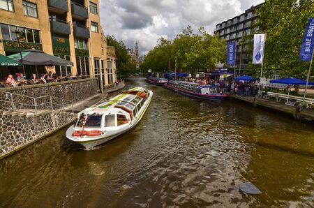 Amsterdam, the Netherlands, August 2019. On the right, along the canal bank, a landing place for the Blue Boat Company: a tourist boat company to visit the city.のeditorial素材