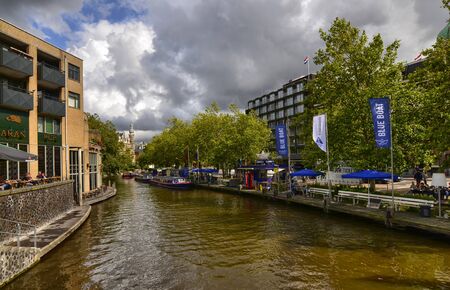 Amsterdam, the Netherlands, August 2019. On the right, along the canal bank, a landing place for the Blue Boat Company: a tourist boat company to visit the city.のeditorial素材